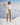 Person standing on a snowy mountain with a snowy mountain range in the background
