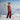 Person standing in a snowy landscape with mountains in the background