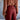 Person wearing a brown blouse and red pants against a blurred background