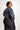 Person wearing a colorful patterned blouse with a plain background