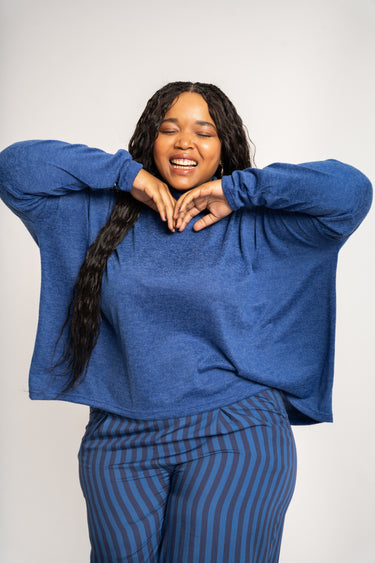 Woman wearing a blue outfit with a white background