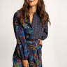 Woman wearing a colorful floral outfit on a white background
